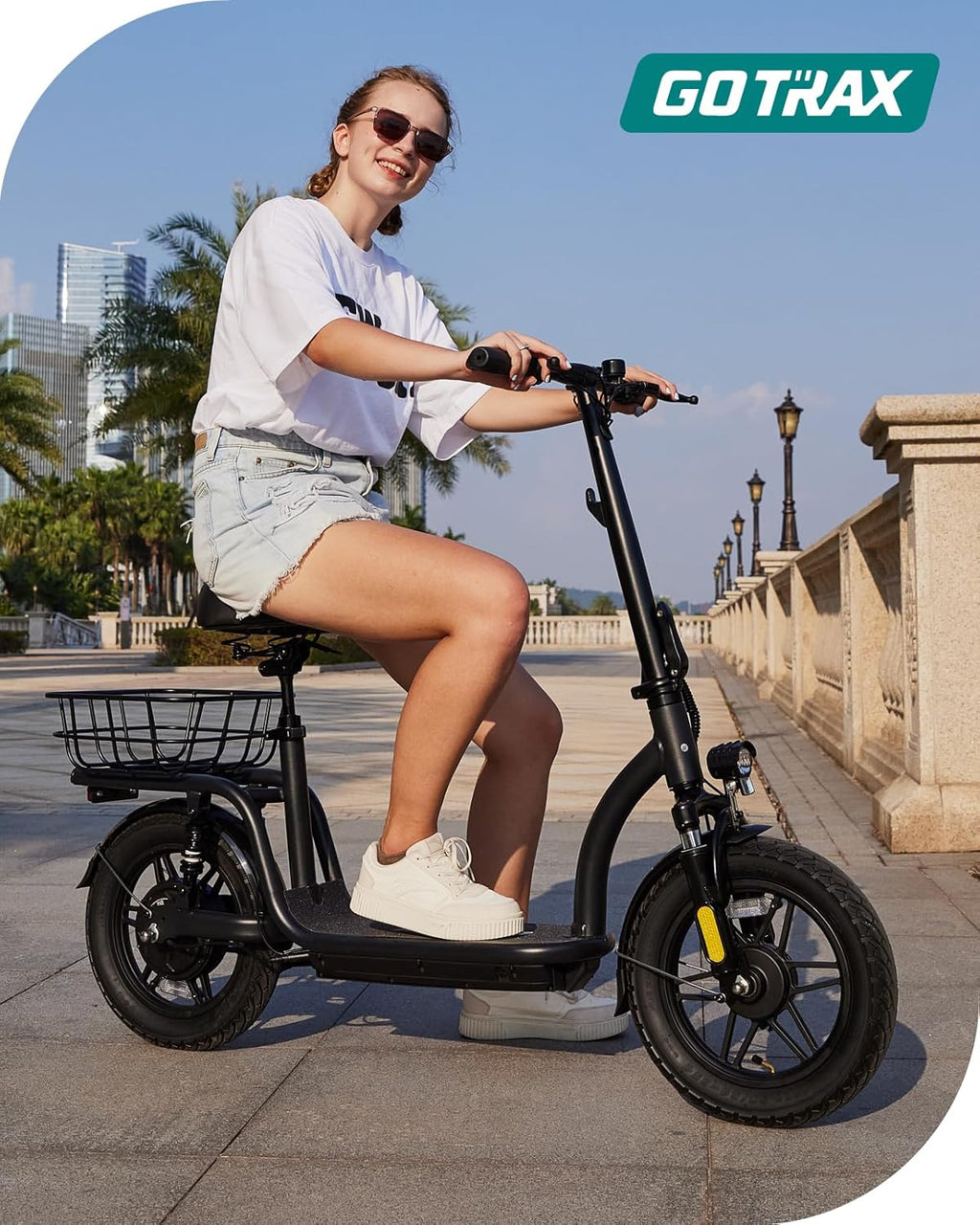 Gotrax adult electric scooter with seat, maximum range of 19-25 miles, all-terrain tires, wide pedals, padded seat, and carrycot wourant